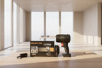 A cordless vacuum cleaner and its packaging box are displayed on a wooden surface, alongside a charging brick and a battery pack. The vacuum is black with a red trigger switch, and the box features orange text reading 'VIOLENT FAN' and '35000PA'.